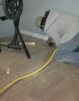 Michel Rousseau terminant l'installation de plancher flottant dans un sous-sol d'une maison de Laval.